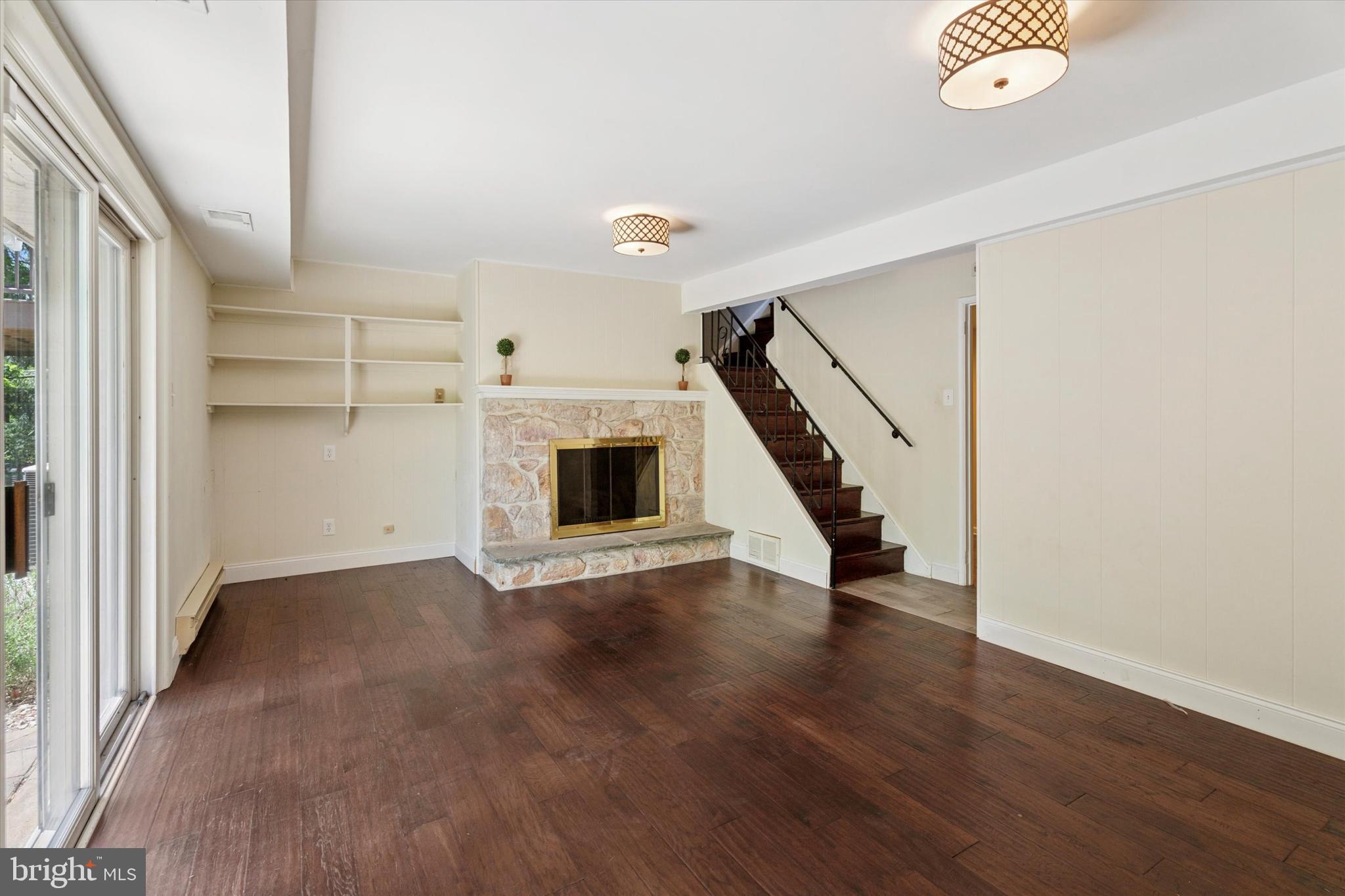 317 Hilltop Road Paoli, PA 19301 - Photo 17 of 25 an empty room with wooden floor and staircase