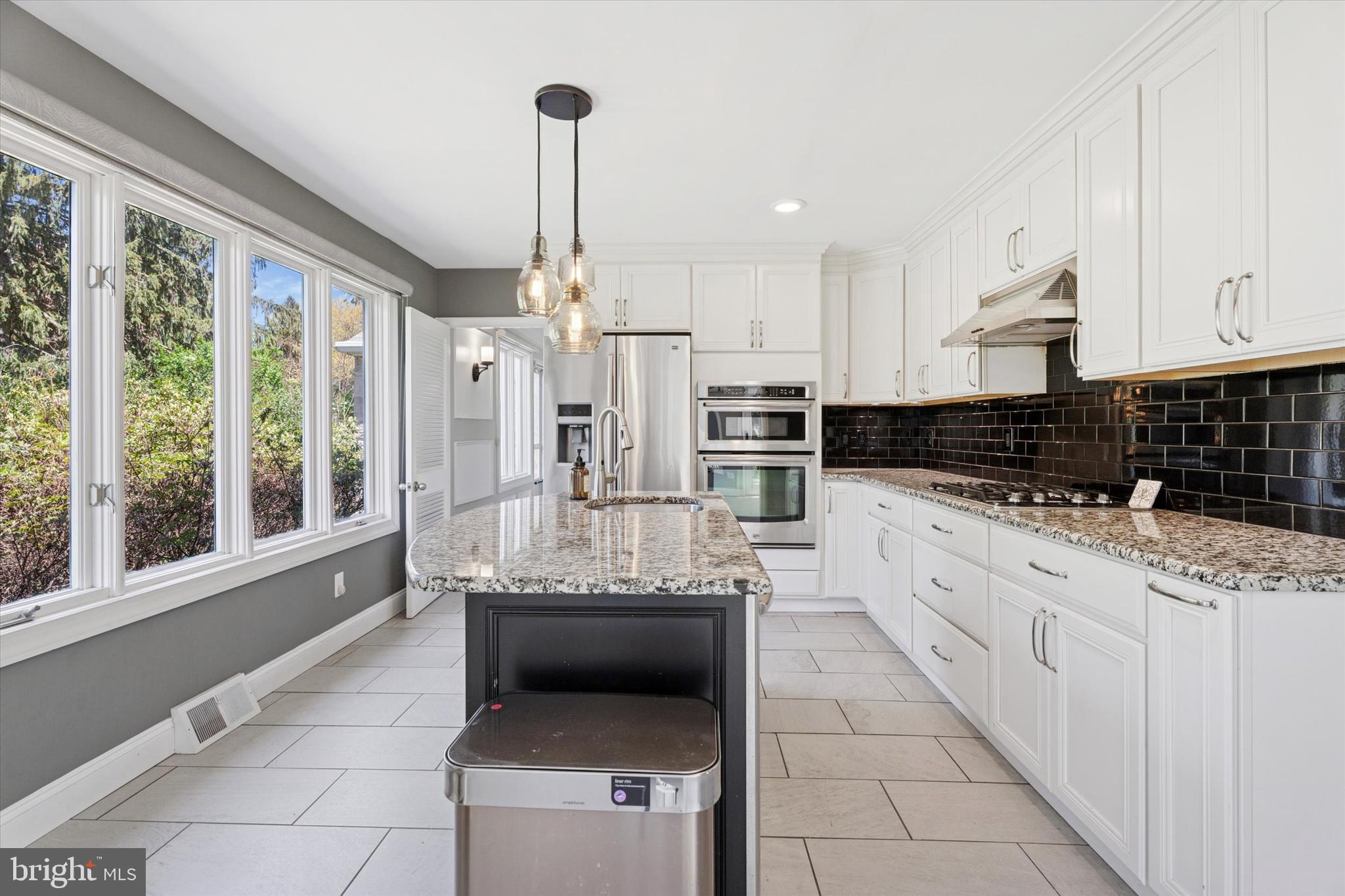 317 Hilltop Road Paoli, PA 19301 - Photo 2 of 25 a large white kitchen with stainless steel appliances