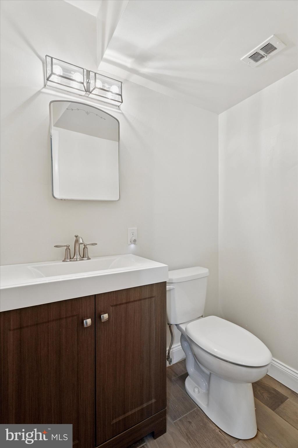 317 Hilltop Road Paoli, PA 19301 - Photo 21 of 25 a bathroom with a sink a toilet and mirror