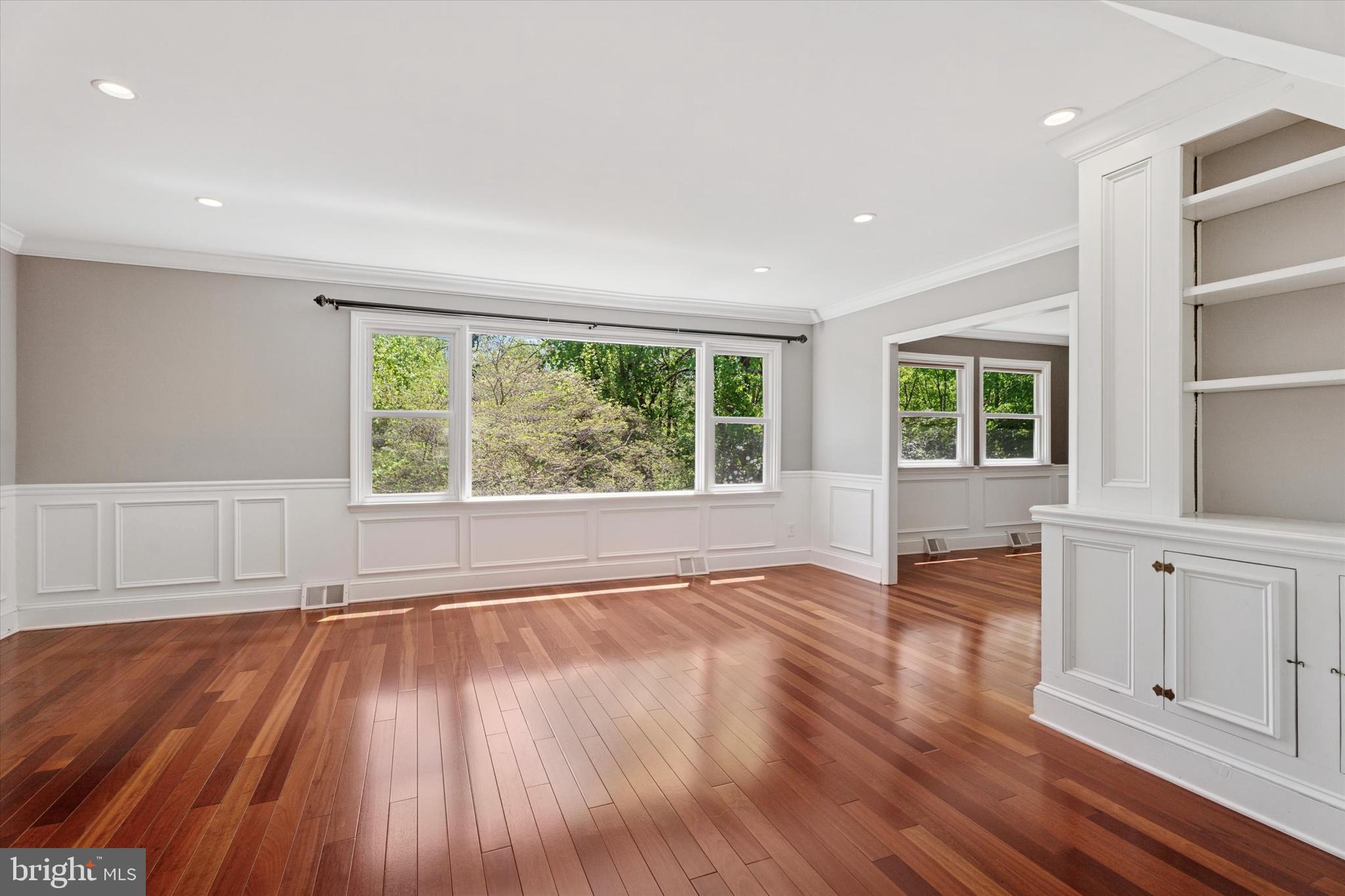 317 Hilltop Road Paoli, PA 19301 - Photo 7 of 25 a view of an empty room with wooden floor and a window