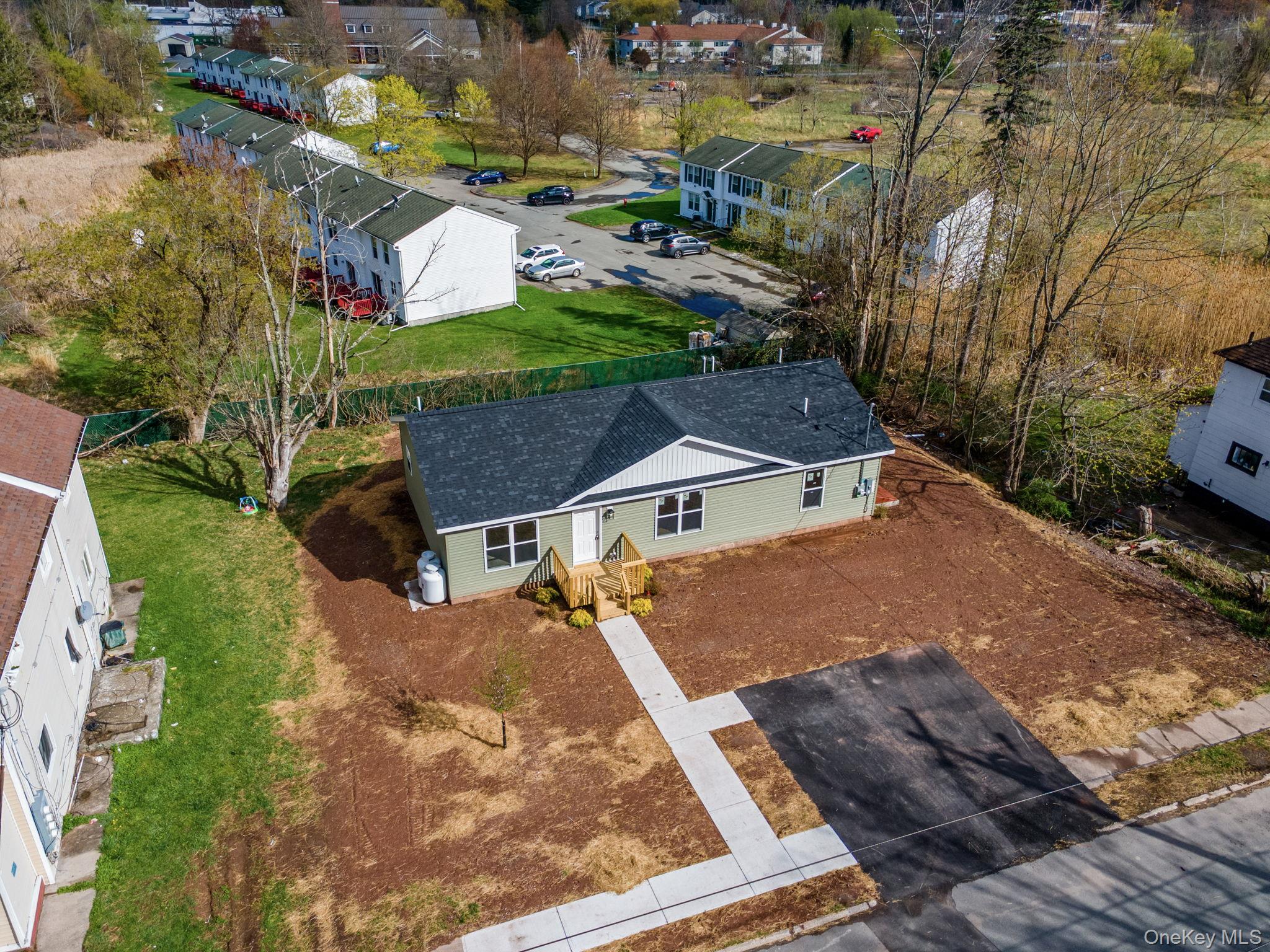 23 Spring Street Monticello, NY 12701 - Photo 5 of 44 an aerial view of a house with a yard basket ball court and outdoor seating