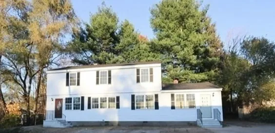 a view of building with large windows and a tree