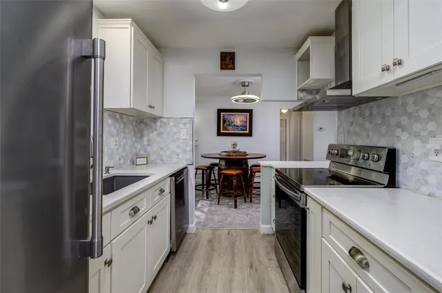 a kitchen with stainless steel appliances granite countertop a stove and a sink