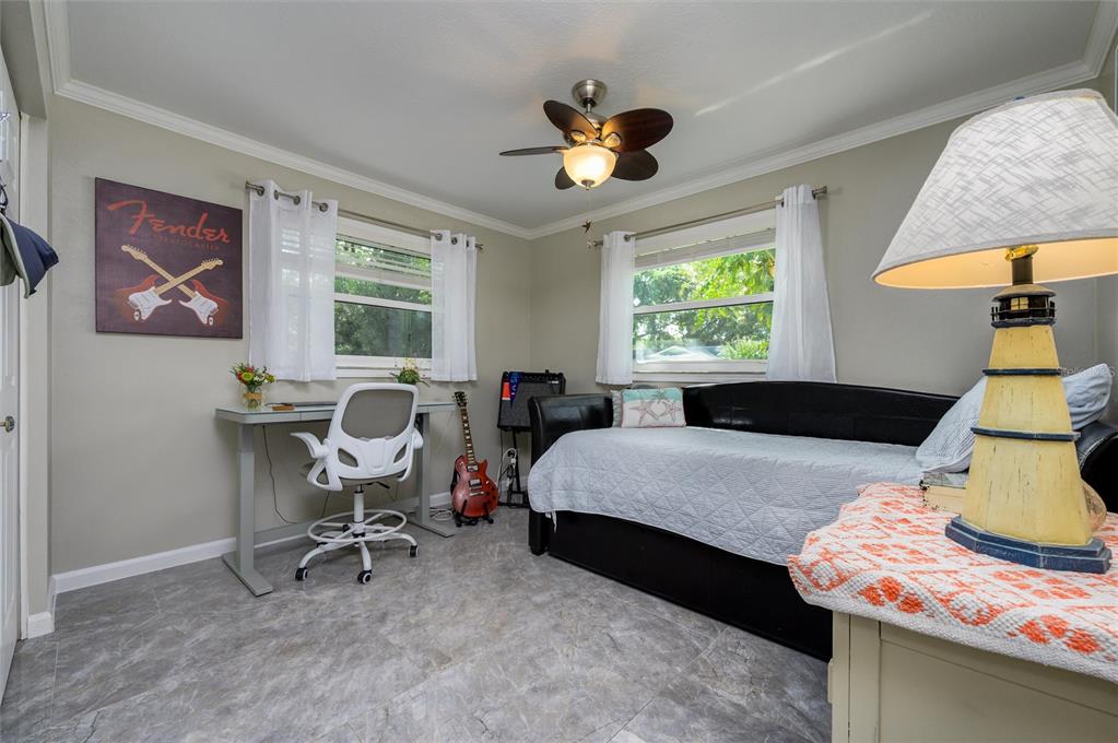 1472 Queen Anne Drive Palm Harbor, FL 34684 - Photo 16 of 34 a bed room with a bed and a chair