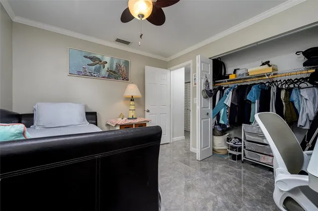 a bedroom with a bed and a view of closet