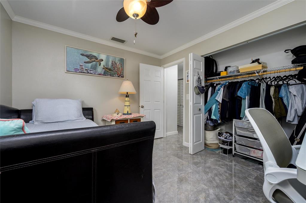 1472 Queen Anne Drive Palm Harbor, FL 34684 - Photo 17 of 34 a bedroom with a bed and a view of closet