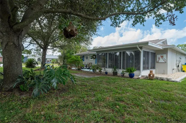 a view of a house with backyard porch and sitting area