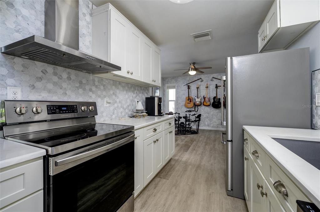 1472 Queen Anne Drive Palm Harbor, FL 34684 - Photo 8 of 34 a kitchen with a stove and a microwave