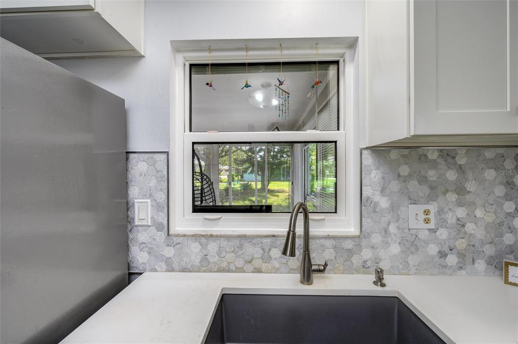 1472 Queen Anne Drive Palm Harbor, FL 34684 - Photo 10 of 34 a bathroom with a sink and a mirror