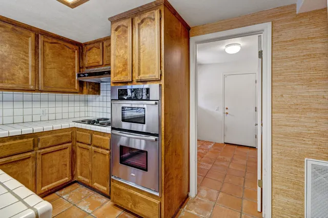 a kitchen with stainless steel appliances granite countertop a stove and a sink