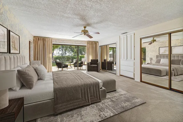 a bedroom with a large bed and a chandelier
