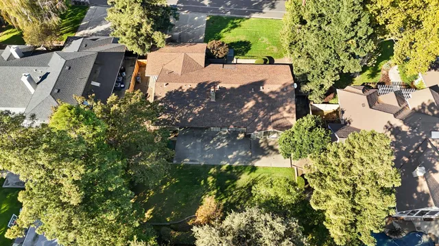 an aerial view of a house with a yard