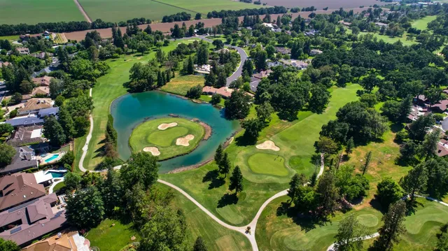 an aerial view of a house with a yard and swimming pool