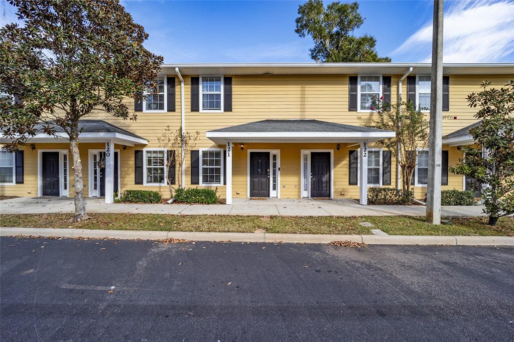 2933 Southwest 35th Place, Unit 121 Gainesville, FL 32608 - Photo 1 of 1 a front view of a house with a garden