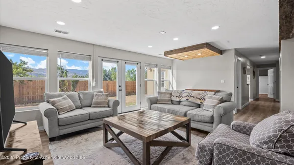 a living room with furniture and a large window