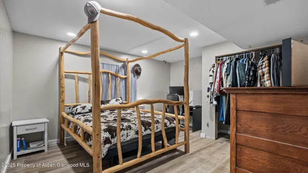 a bedroom with a bed next to a window