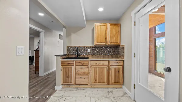 a bathroom with a granite countertop sink a mirror and a bathtub
