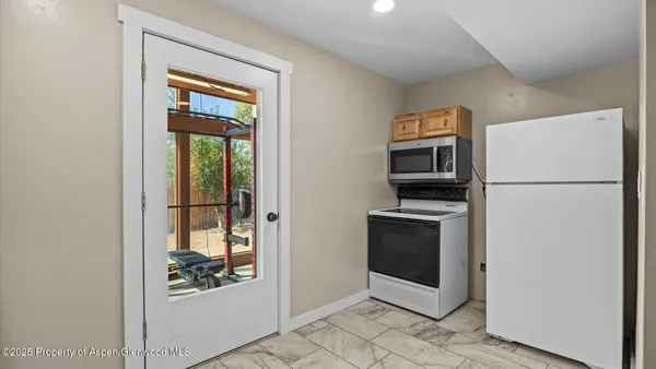 a kitchen with a refrigerator and a stove