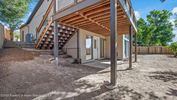 a view of an house with backyard and stairs