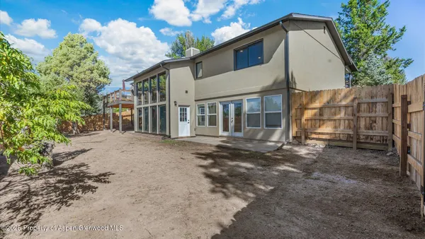 a view of a house with a backyard