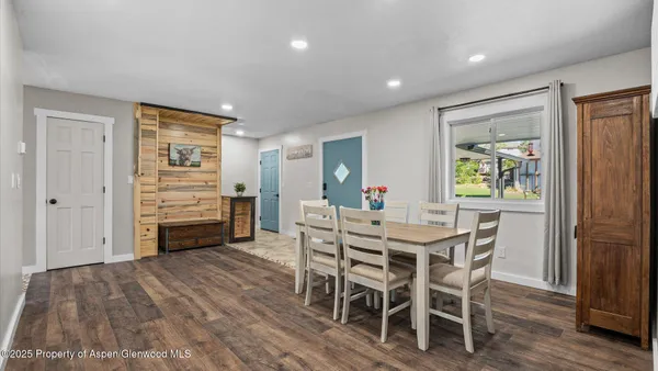 a view of a dining room with furniture and wooden floor
