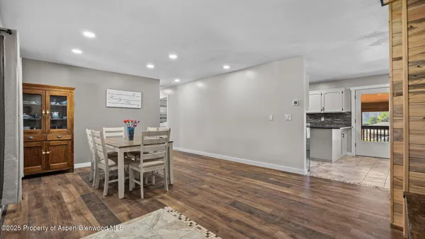 a view of a dining room with furniture and wooden floor