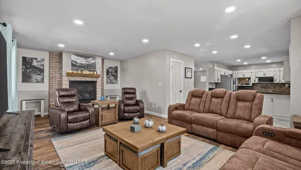 a living room with furniture and a fireplace