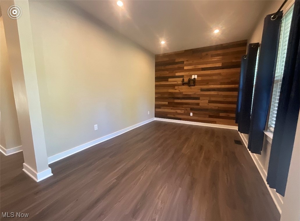 4659 Newcomer Road Kent, OH 44240 - Photo 2 of 23 Unfurnished room featuring dark wood-type flooring and wooden walls