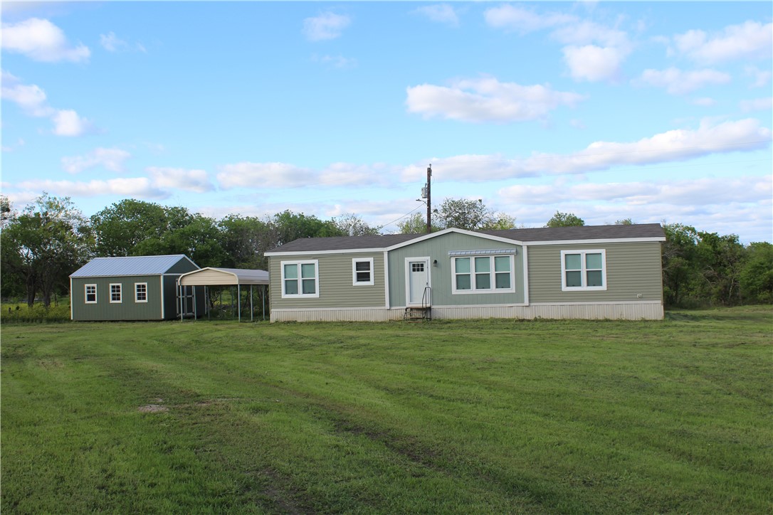a view of a house with a big yard