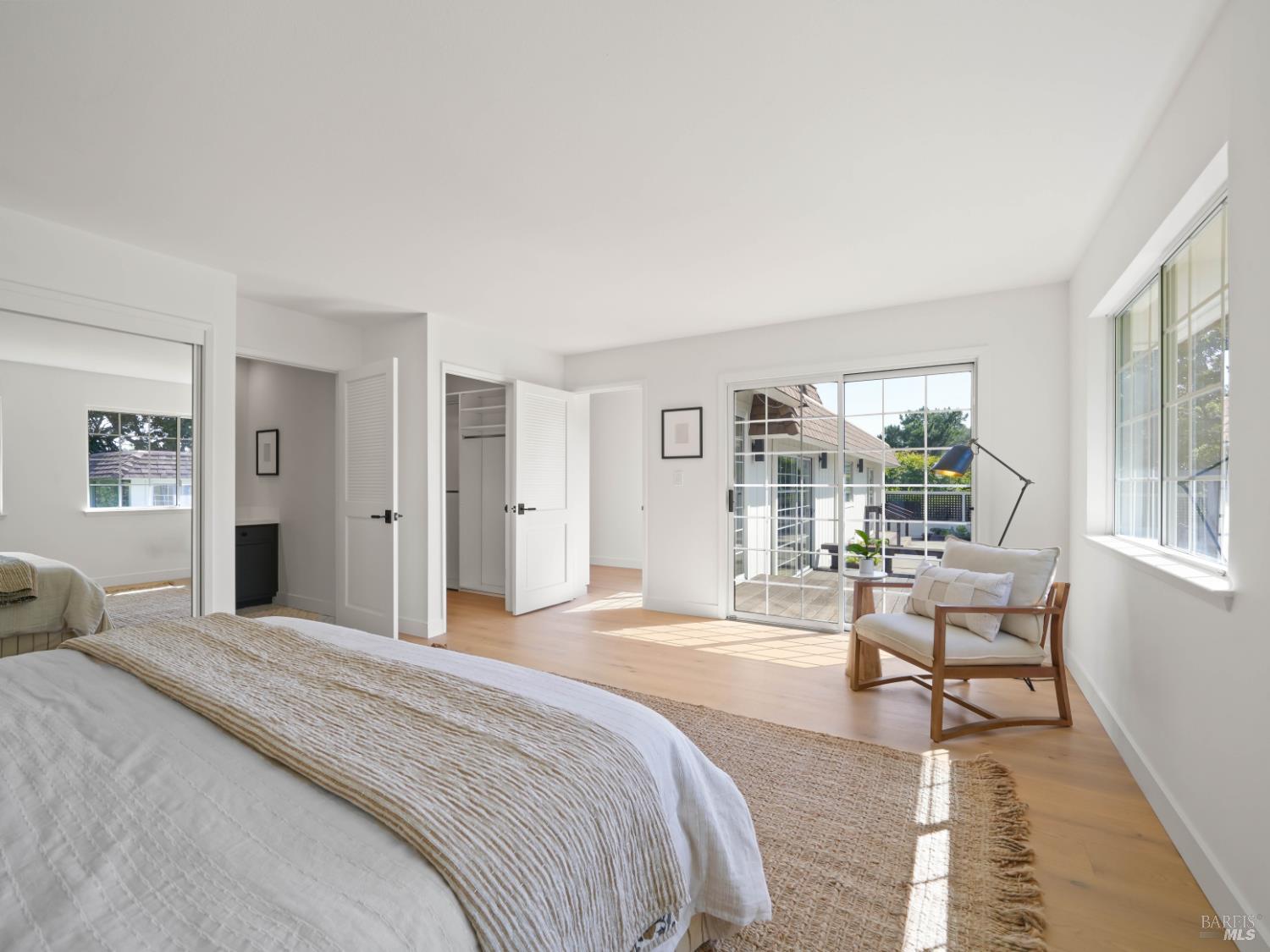 148 Dominican Drive San Rafael, CA 94901 - Photo 25 of 60 a bedroom with a bed and large windows