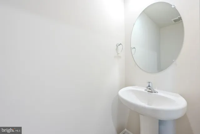 a kitchen with granite countertop a sink a counter space cabinets and stainless steel appliances