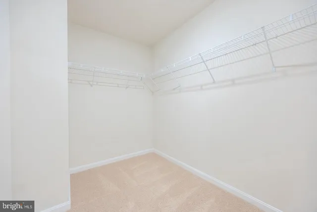 a bathroom with a granite countertop sink a mirror and a shower