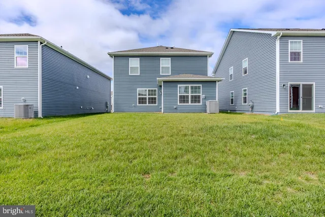 a big house with a big yard and large trees