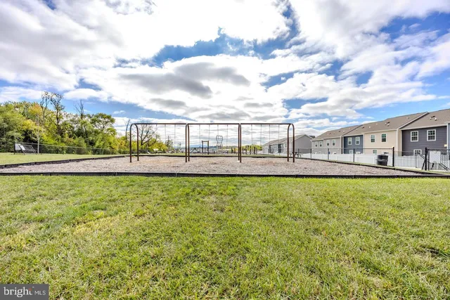 a view of a swimming pool with a patio and a yard