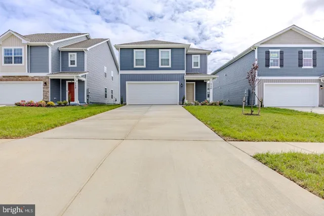 a kitchen with stainless steel appliances granite countertop a sink a stove a microwave and refrigerator