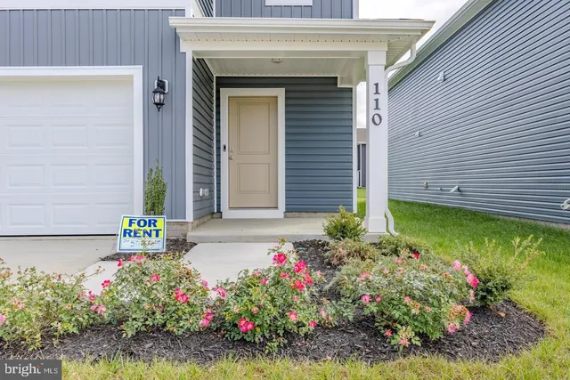 a front view of a house with a garden and entryway