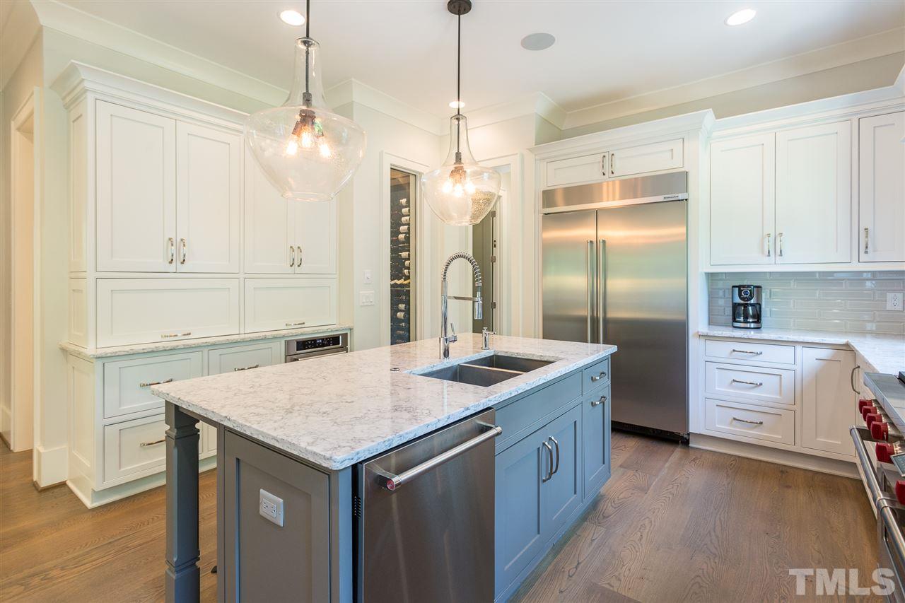 1613 Ridge Road Raleigh, NC 27607 - Photo 11 of 30 a kitchen that has a lot of cabinets in it