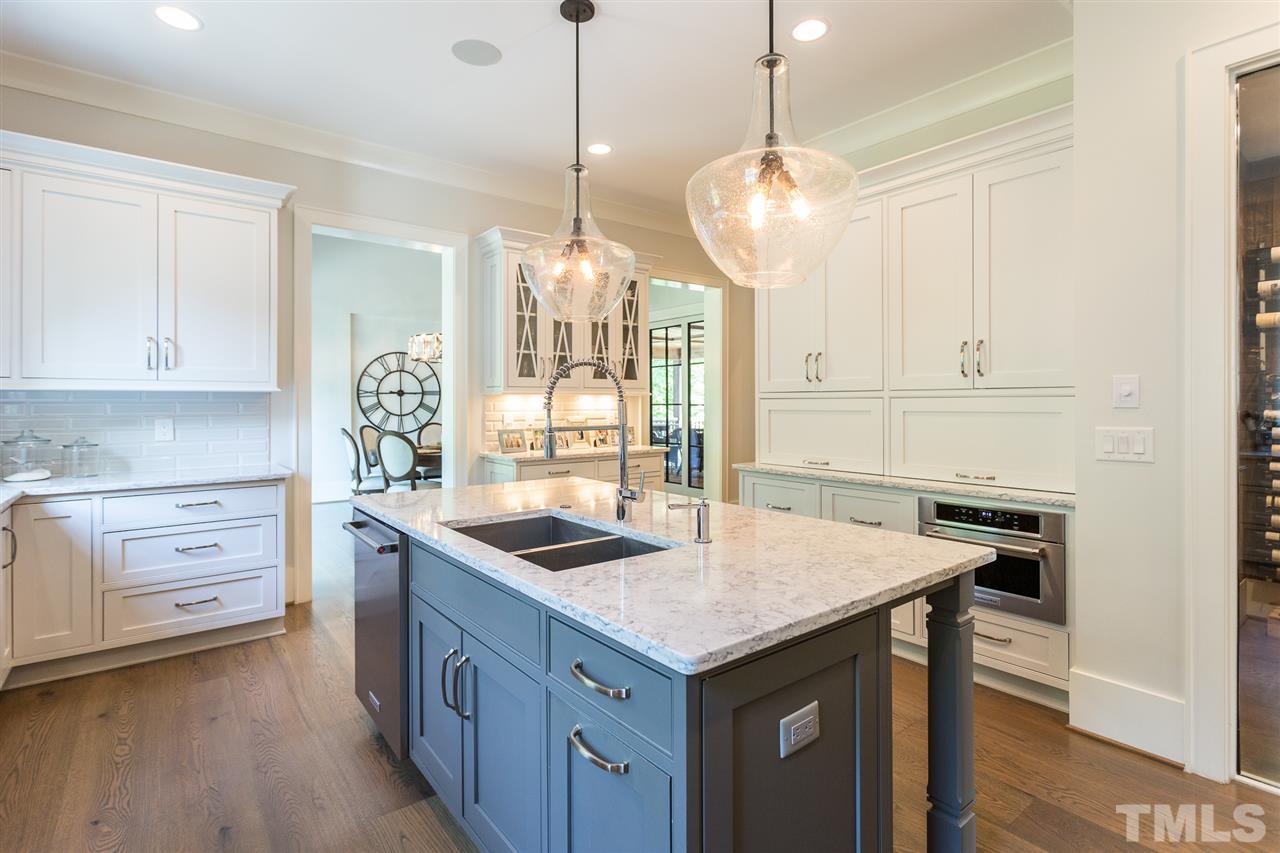 1613 Ridge Road Raleigh, NC 27607 - Photo 12 of 30 a kitchen that has a sink a stove and a table in it