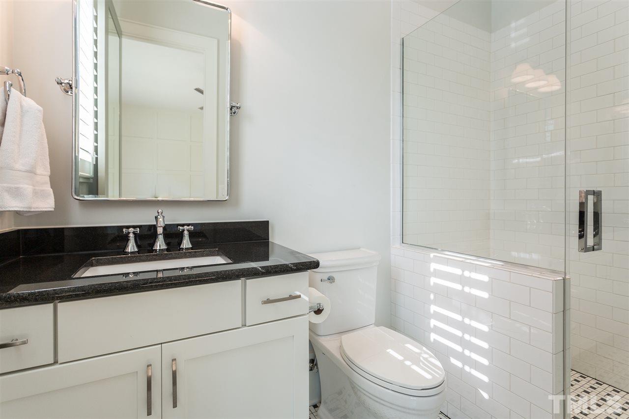 1613 Ridge Road Raleigh, NC 27607 - Photo 17 of 30 a bathroom with a granite countertop sink a toilet and a mirror