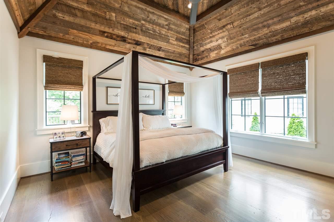 1613 Ridge Road Raleigh, NC 27607 - Photo 19 of 30 a bed sitting in a spacious bedroom next to a window