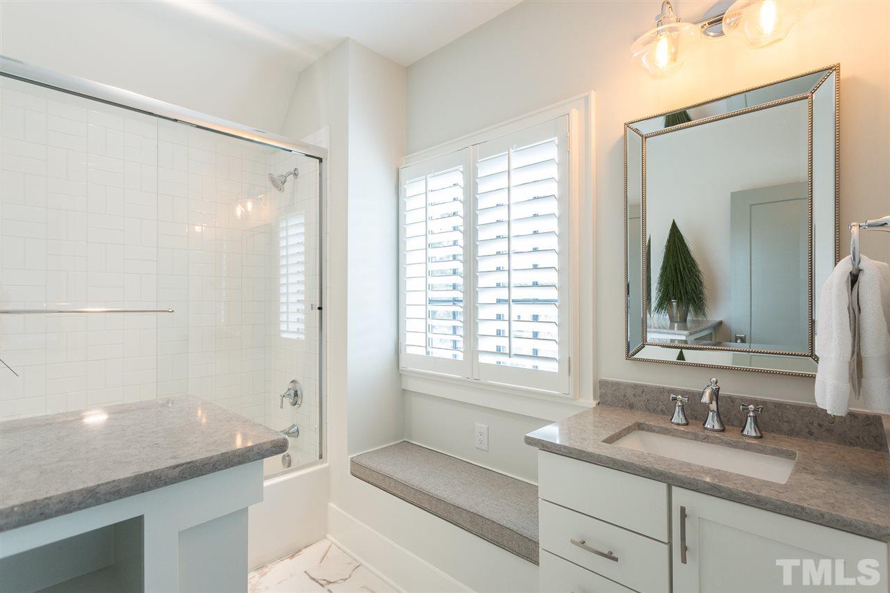 1613 Ridge Road Raleigh, NC 27607 - Photo 24 of 30 a bathroom with a granite countertop sink mirror and a bathtub