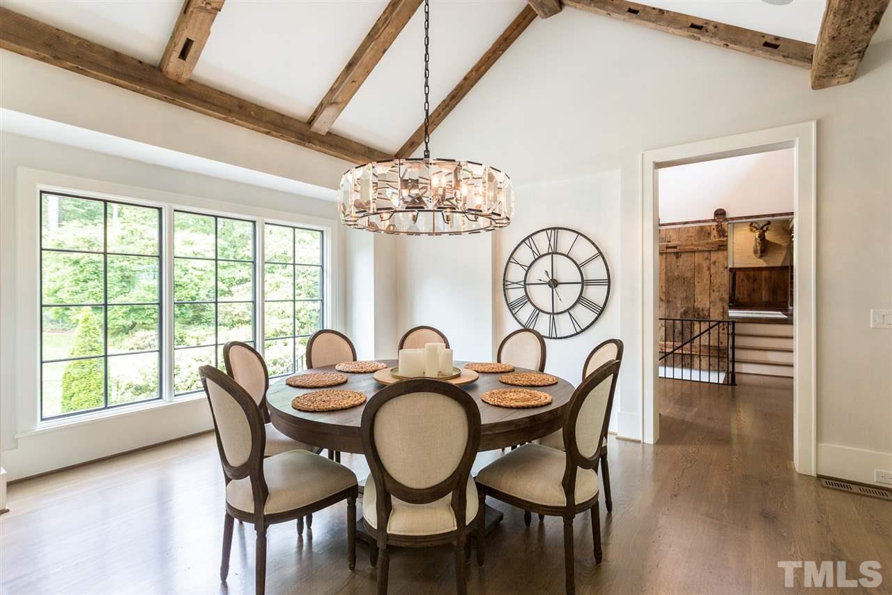 1613 Ridge Road Raleigh, NC 27607 - Photo 9 of 30 a dining room with furniture a chandelier and wooden floor