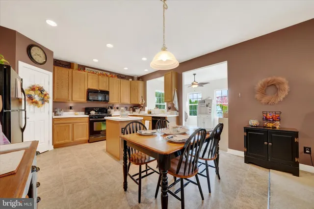 a kitchen with stainless steel appliances kitchen island granite countertop a sink and cabinets