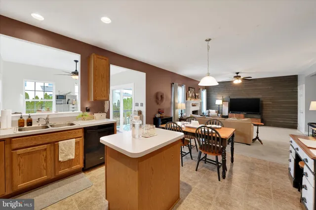 a large kitchen with a table and chairs