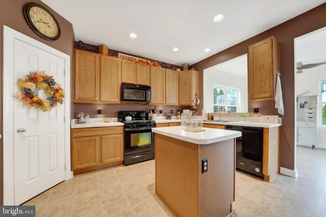 a kitchen with a sink stove and a refrigerator