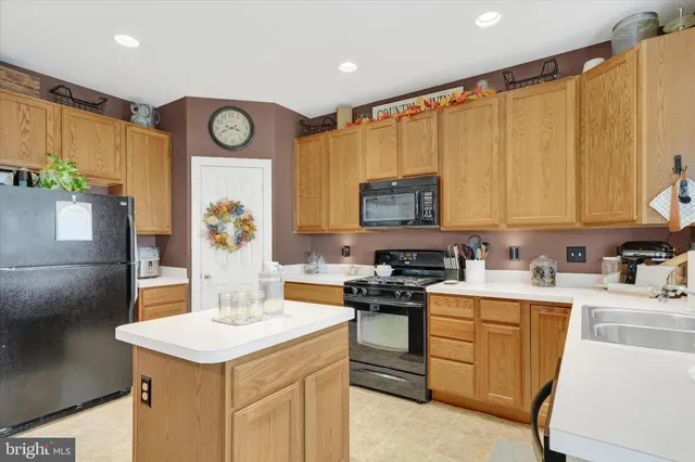 a kitchen with a sink a stove and chairs