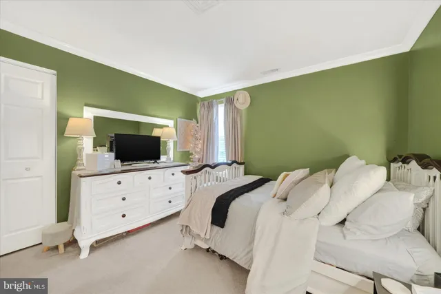 a bedroom with a bed and flat screen tv