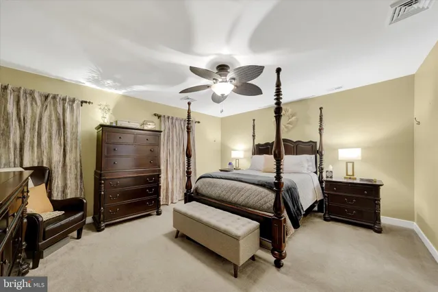 a bedroom with bed and a chandelier