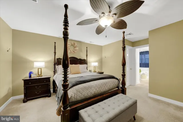 a bedroom with a bed chandelier and a window