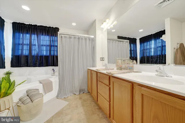 a bathroom with a sink a vanity and a bathtub
